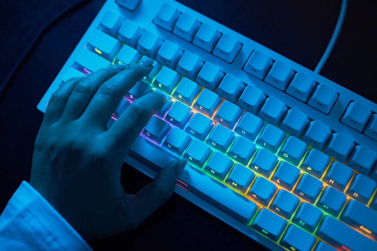 An ergonomic keyboard and mouse laid out on a desk mat