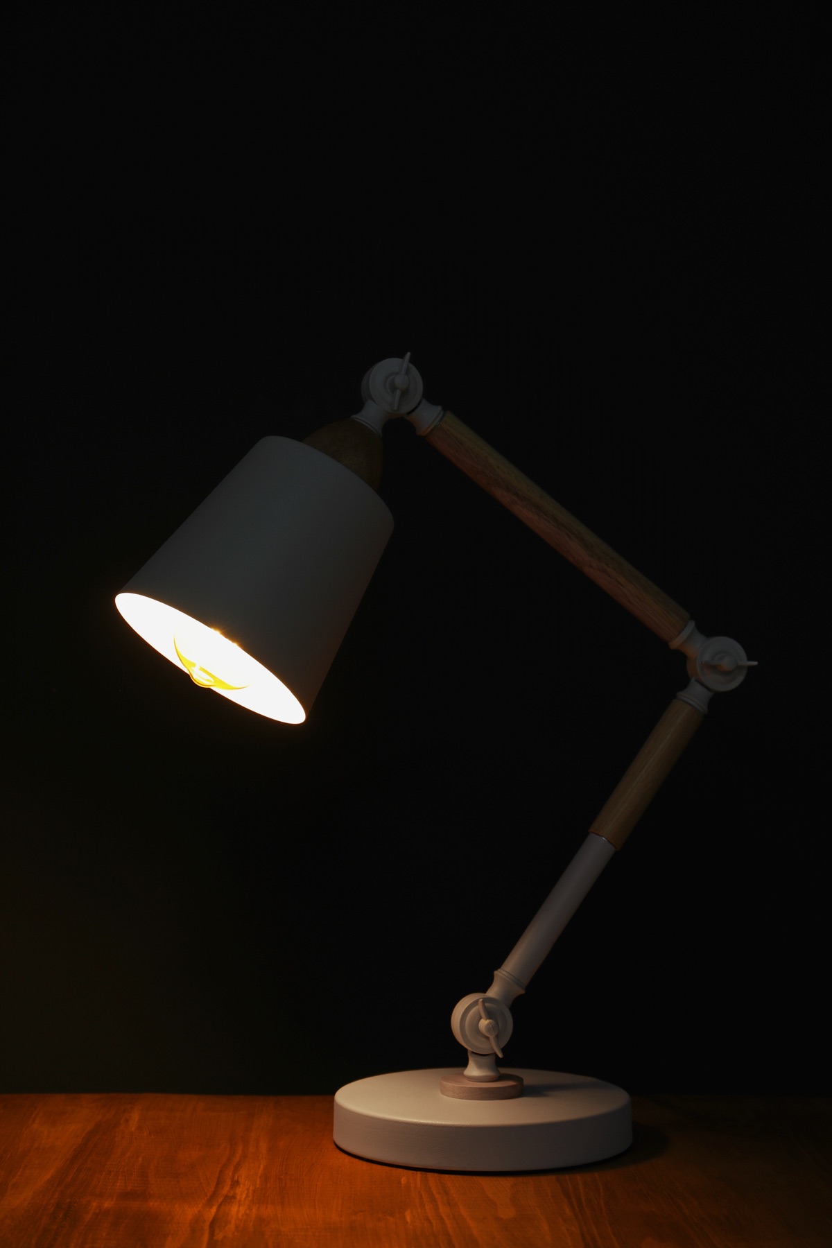 A monitor light bar and desk lamp illuminating a workspace