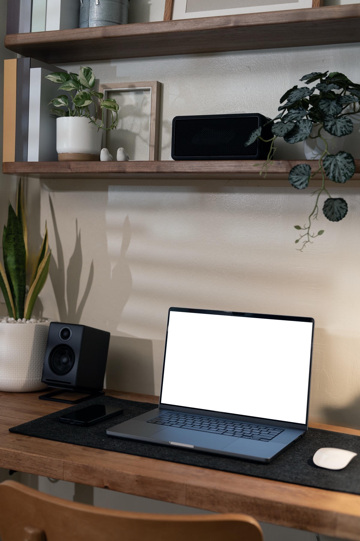 An open laptop on an uncluttered desk with a notebook and coffee